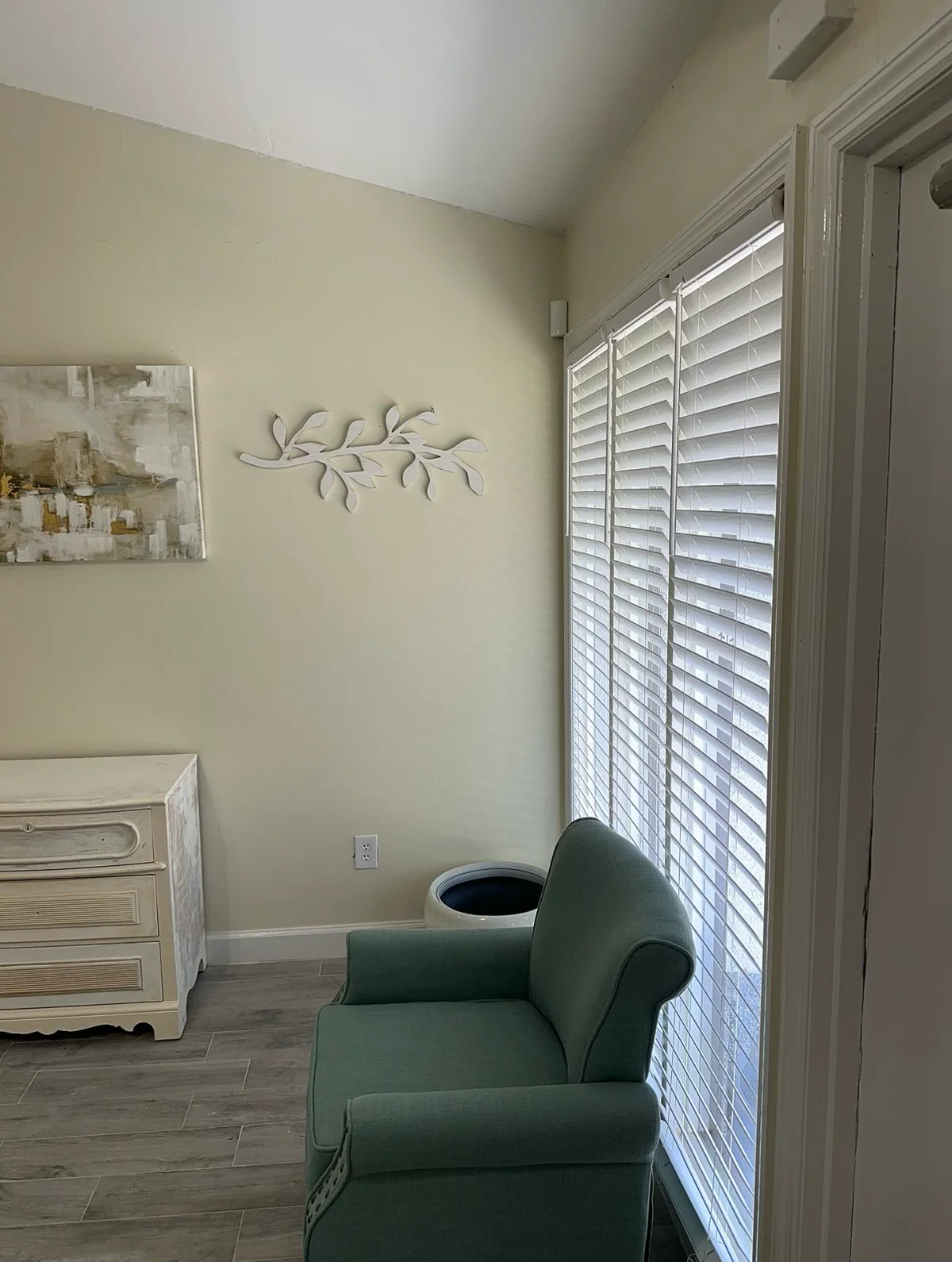 Quiet welcome room with a sage chair and natural light